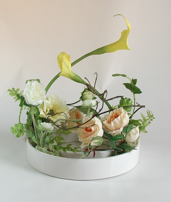 Harmony Crossing silk flowers in donut-shaped vase